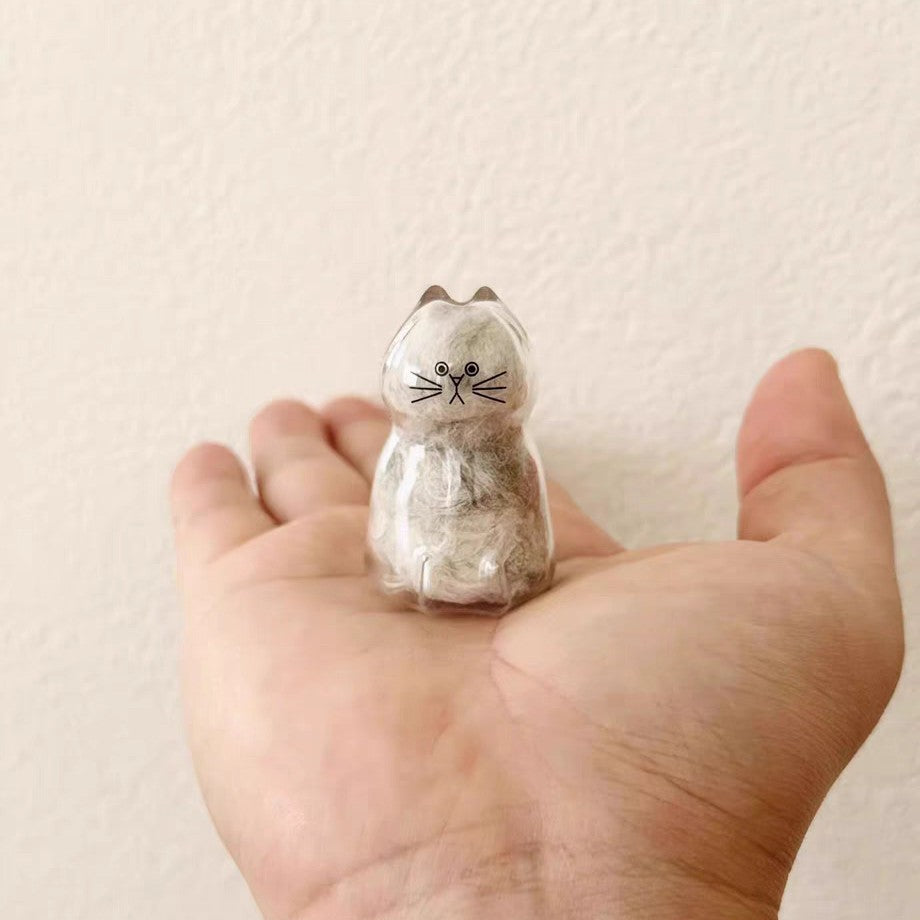 Pet Hair Memorial Capsule Keychain by CC+Tea featuring a clear capsule with space for pet hair and a keyring attachment.