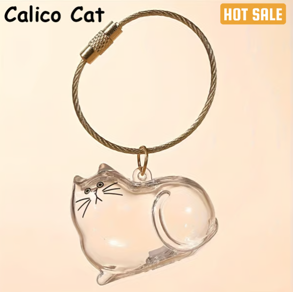 Pet Hair Memorial Capsule Keychain by CC+Tea, a small clear capsule with pet hair inside on a keyring, for memorial keepsake.