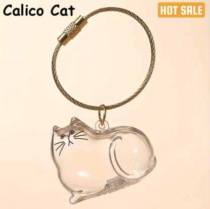 Pet Hair Memorial Capsule Keychain by CC+Tea, a small clear capsule with pet hair inside on a keyring, for memorial keepsake.