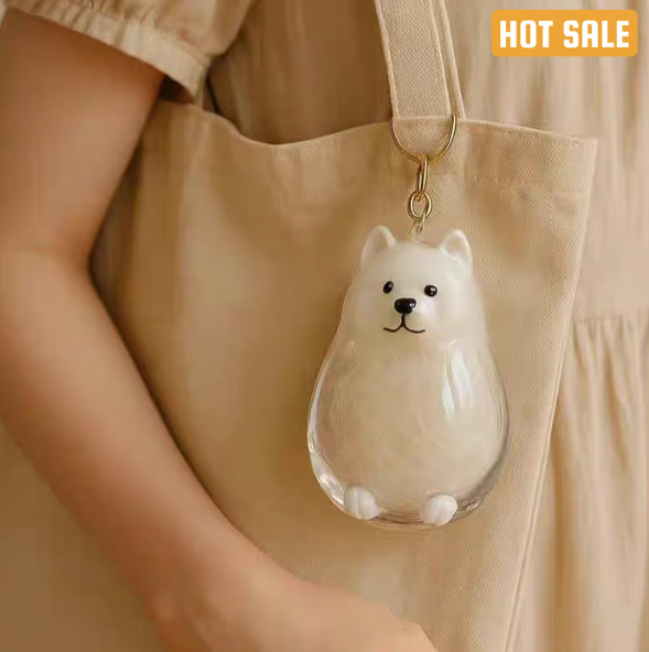 Pet Hair Memorial Capsule Keychain by CC+Tea, small clear capsule holding pet hair with keyring attachment for remembrance.